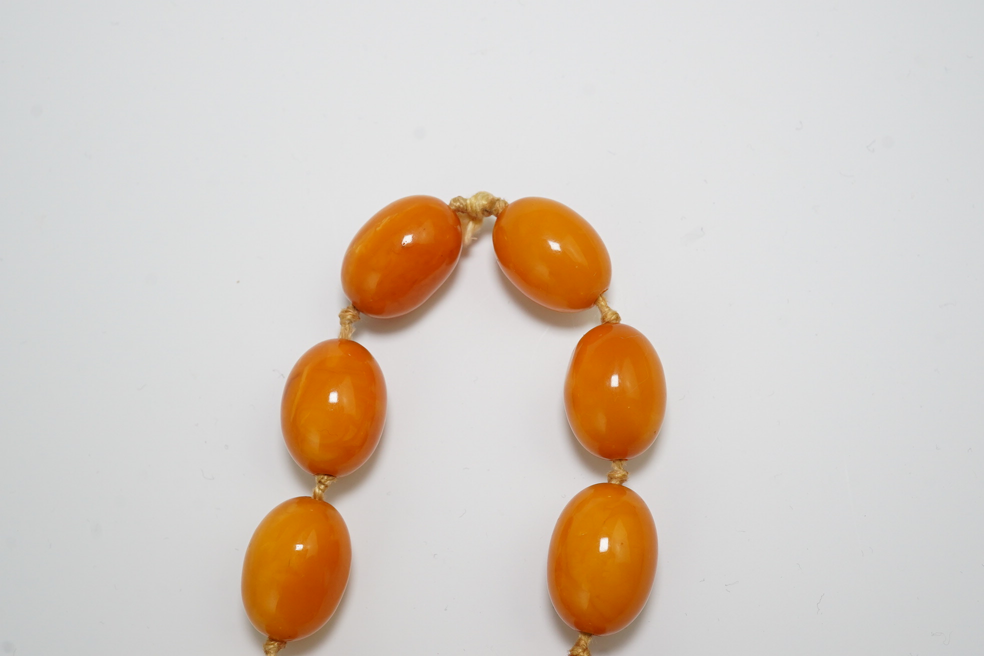 A single strand graduated oval amber bead necklace